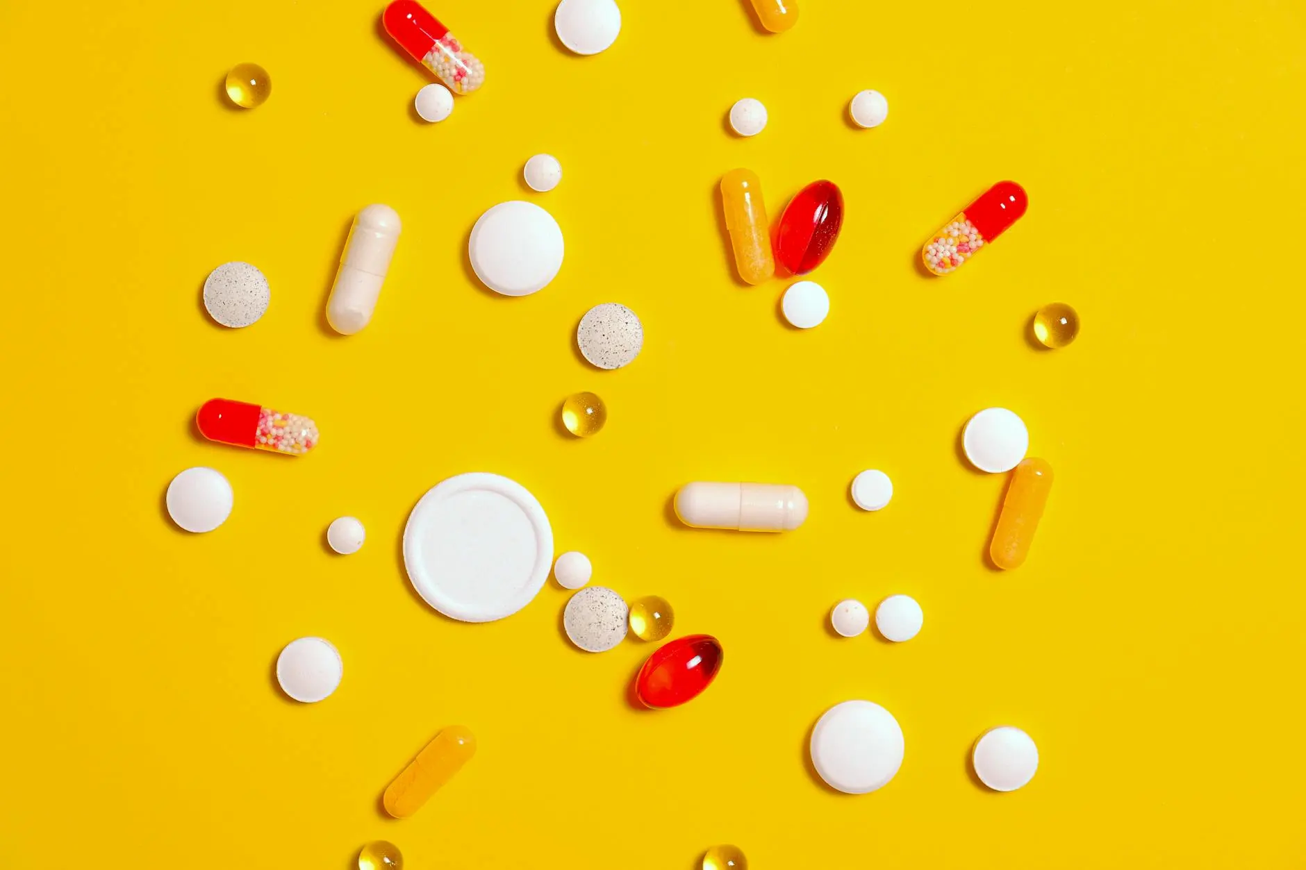 Bunch of Medicine Pill on Yellow Textile